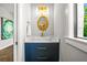 Stylish powder room with a modern vanity, decorative mirror, and unique design at 135 Grant Dr, Sarasota, FL 34236