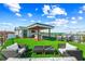 Stylish rooftop deck featuring a covered outdoor kitchen, dining area, lounge seating, and scenic views at 135 Grant Dr, Sarasota, FL 34236