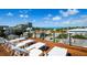 Relaxing rooftop deck featuring comfortable lounge chairs and stunning views of the city and ocean at 135 Grant Dr, Sarasota, FL 34236