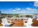 Rooftop deck with stylish seating and panoramic views of the city and ocean at 135 Grant Dr, Sarasota, FL 34236