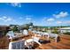 Spacious rooftop deck with white furniture, perfect for enjoying the beautiful ocean views at 135 Grant Dr, Sarasota, FL 34236
