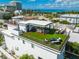Expansive rooftop deck with outdoor kitchen, dining area, lounge seating, and beautiful ocean views at 135 Grant Dr, Sarasota, FL 34236