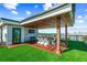 Relaxing rooftop deck with ocean views, dining area, TV, and artificial grass, perfect for outdoor entertaining at 135 Grant Dr, Sarasota, FL 34236