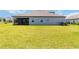 Backyard of home features lush green lawn, screened-in patio, and privacy from neighbors at 14914 15Th E St, Parrish, FL 34219
