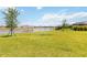 A beautiful backyard with manicured lawn, a serene pond view, and fenced property lines at 14914 15Th E St, Parrish, FL 34219