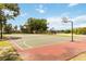 Outdoor basketball court with two hoops, playground, and surrounding trees provides recreational space at 14914 15Th E St, Parrish, FL 34219