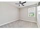 Small bedroom with plush gray carpeting and a ceiling fan at 14914 15Th E St, Parrish, FL 34219