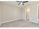 Small bedroom with plush gray carpeting, ceiling fan, and a closet at 14914 15Th E St, Parrish, FL 34219