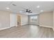 Bedroom with a light ceiling fan, a window, and a doorway to a bathroom, with wood-look floors at 14914 15Th E St, Parrish, FL 34219