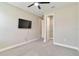 Bedroom featuring neutral-painted walls, carpet, and an entertainment center at 14914 15Th E St, Parrish, FL 34219