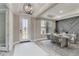 Bright dining room with white marble table, modern light fixture, and stylish accent wall at 14914 15Th E St, Parrish, FL 34219