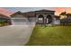 Charming home featuring stone accents, manicured landscaping, and a spacious three-car garage at 14914 15Th E St, Parrish, FL 34219
