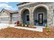 Inviting single-Gathering home with stone arches, mature landscaping, and a spacious two-car garage at 14914 15Th E St, Parrish, FL 34219