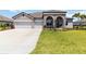 Charming home with a stone and light-colored exterior, a two-car garage, and landscaped yard at 14914 15Th E St, Parrish, FL 34219