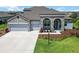 Charming single-Gathering home with stone accents, a well-kept lawn, and a convenient two-car garage at 14914 15Th E St, Parrish, FL 34219