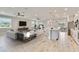 Open-concept living room flowing into a modern kitchen with island seating and ample natural light at 14914 15Th E St, Parrish, FL 34219