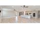 Expansive open-concept living area featuring recessed lights, neutral paint, tile floors, and an adjacent kitchen at 14914 15Th E St, Parrish, FL 34219