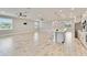 Open-concept living space with modern light-grey kitchen and eat-in island at 14914 15Th E St, Parrish, FL 34219