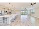 Spacious living area with an open kitchen, an oversized island, recessed lights, and wood-look tile flooring at 14914 15Th E St, Parrish, FL 34219