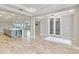Open-concept living area with a kitchen island, tile floors, recessed lighting, and elegant fixtures at 14914 15Th E St, Parrish, FL 34219