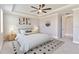 Cozy main bedroom with tray ceiling, ceiling fan, neutral decor, and carpeted floors at 14914 15Th E St, Parrish, FL 34219