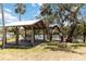 Lakeside wooden pavilion with picnic tables, perfect for outdoor gatherings and scenic views at 14914 15Th E St, Parrish, FL 34219
