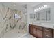 Modern bathroom featuring a glass-enclosed shower with marble tile and a dark wood vanity at 1612 Starling Dr # 101, Sarasota, FL 34231