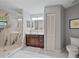 Elegant bathroom with marble shower, wood vanity, and modern fixtures at 1612 Starling Dr # 101, Sarasota, FL 34231