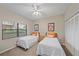 Cozy bedroom with two twin beds, ceiling fan, and closet space at 1612 Starling Dr # 101, Sarasota, FL 34231