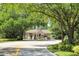 Gated community entrance with mature trees and lush landscaping at 1612 Starling Dr # 101, Sarasota, FL 34231
