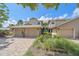 Charming townhouse with brick driveway, lush landscaping, and a welcoming facade on a sunny day at 1612 Starling Dr # 101, Sarasota, FL 34231
