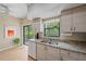 Bright kitchen sink with a window that provides an outside view and modern appliances at 1612 Starling Dr # 101, Sarasota, FL 34231
