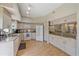 Spacious kitchen featuring light wood floors, cabinets, granite countertops and modern appliances at 1612 Starling Dr # 101, Sarasota, FL 34231
