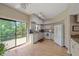 Bright kitchen with modern appliances, granite countertops, and a view to the outside patio at 1612 Starling Dr # 101, Sarasota, FL 34231