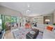Inviting living room with hardwood floors, a screened lanai, and ample seating for entertaining at 1612 Starling Dr # 101, Sarasota, FL 34231