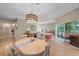 Open-concept living space featuring hardwood floors, dining area, and a cozy seating arrangement at 1612 Starling Dr # 101, Sarasota, FL 34231