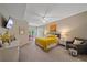 Spacious main bedroom with a ceiling fan, desk, colorful bedding, and comfortable sitting area at 1612 Starling Dr # 101, Sarasota, FL 34231