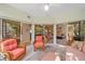 Bright sunroom with tile floors, glass doors, and wicker furniture at 1612 Starling Dr # 101, Sarasota, FL 34231