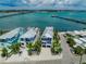 Aerial view of waterfront homes with a gorgeous ocean backdrop and neighborhood street access at 201 Bay N Dr, Bradenton Beach, FL 34217
