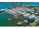 Stunning aerial view of coastal neighborhood with beach access, multiple docks, and beautiful blue water views at 201 Bay N Dr, Bradenton Beach, FL 34217