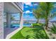 Beautiful backyard with a putting green, dock, and picturesque waterfront views under a sunny sky at 201 Bay N Dr, Bradenton Beach, FL 34217