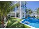 Stunning backyard with a pool, putting green, outdoor seating, and lush tropical landscaping at 201 Bay N Dr, Bradenton Beach, FL 34217