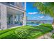 Lush backyard featuring a well-manicured putting green and stunning waterfront vistas at 201 Bay N Dr, Bradenton Beach, FL 34217