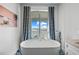 Luxurious bathroom with freestanding tub and sliding doors to deck overlooking the water at 201 Bay N Dr, Bradenton Beach, FL 34217
