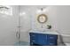 Bathroom featuring a stylish vanity and a walk-in shower with tile at 201 Bay N Dr, Bradenton Beach, FL 34217