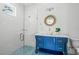 Bright bathroom boasts a stylish blue vanity, eye-catching tile floor, and glass shower at 201 Bay N Dr, Bradenton Beach, FL 34217