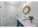 Bathroom featuring a modern vanity and a walk-in shower with tile at 201 Bay N Dr, Bradenton Beach, FL 34217
