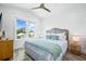 Relaxing bedroom with a ceiling fan, wide window, and coastal decor accents at 201 Bay N Dr, Bradenton Beach, FL 34217