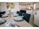A dining room is set for a meal, with views into the modern kitchen at 201 Bay N Dr, Bradenton Beach, FL 34217