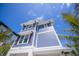 Charming two-story home with blue siding and a well-maintained exterior at 201 Bay N Dr, Bradenton Beach, FL 34217